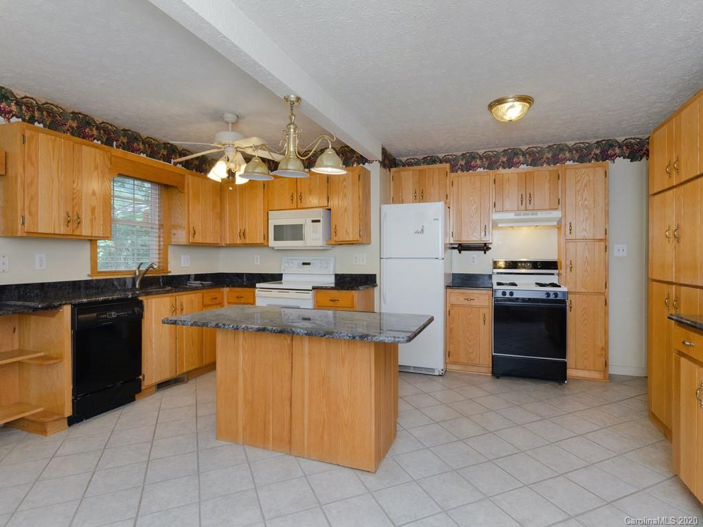124 Trantham Road Canton, NC 28716 - Photo 6 of 18 a kitchen with stainless steel appliances granite countertop a refrigerator and a stove top oven