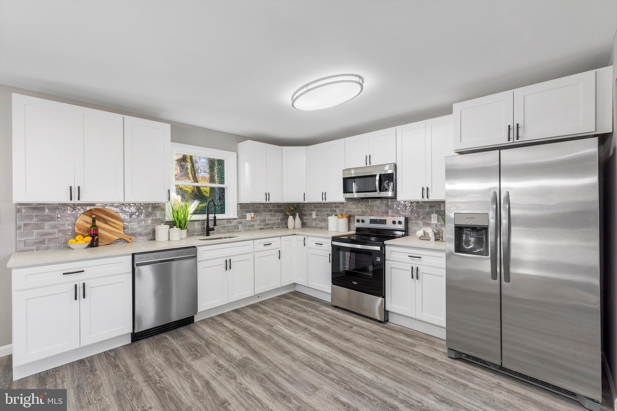 712 St Marys Road Pylesville, MD 21132 - Photo 2 of 43 a kitchen with white cabinets stainless steel appliances and a window