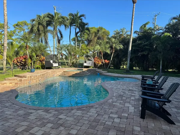 a view of a swimming pool with sitting area