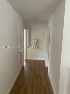 a bedroom with a bed a couch and a flat screen tv