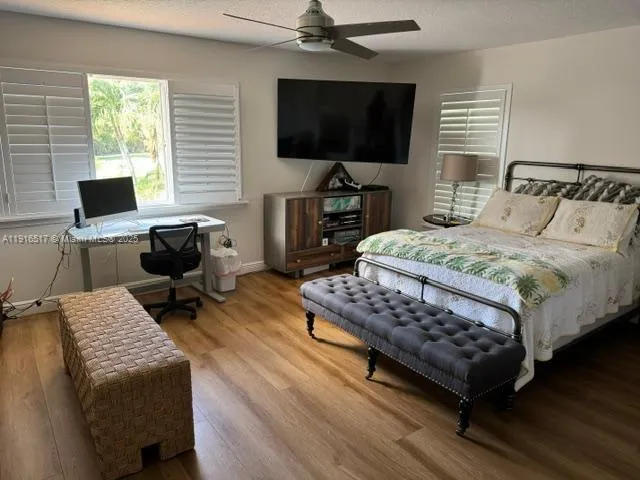 a spacious bedroom with a bed a couch and a window