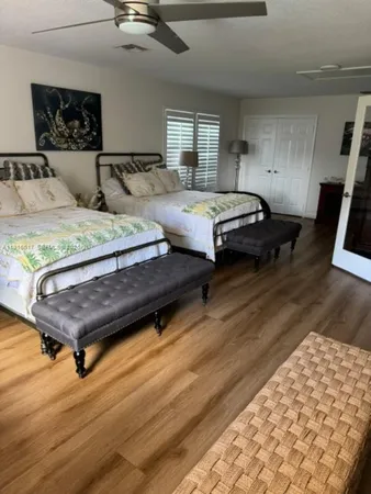 a bedroom with a bed lamp and a dresser