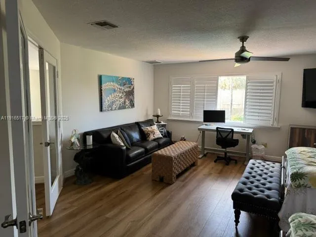 a bedroom with a bed lamp and a dresser