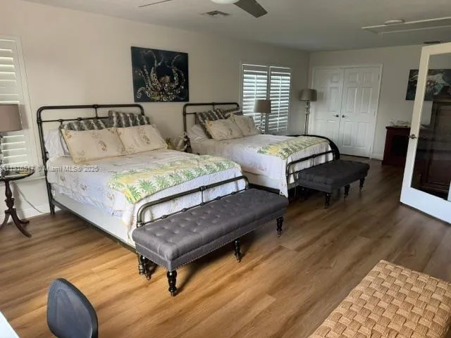 a view of a patio with table and chairs potted plants with wooden floor and fence
