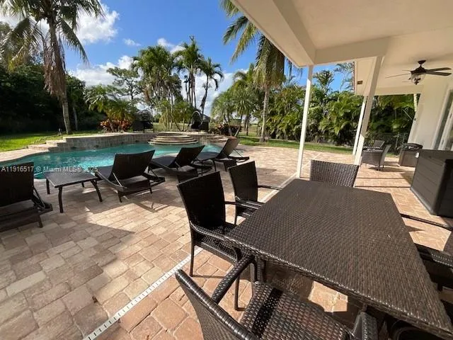 a outdoor space with patio the couches and a dining table with the garden view