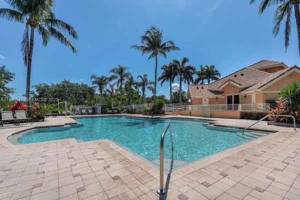 a house with swimming pool in front of it