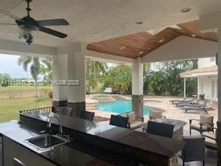 a kitchen with a stove a refrigerator and a fireplace