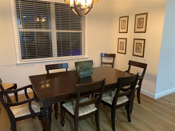 a view of a dining room with furniture and wooden floor