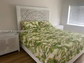 a front view of a house with garden and trees