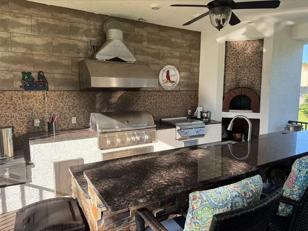 a kitchen with granite countertop a stove and a sink