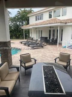 a outdoor living space with patio furniture and a potted plant