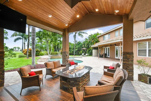 a living room filled with furniture and a potted plant