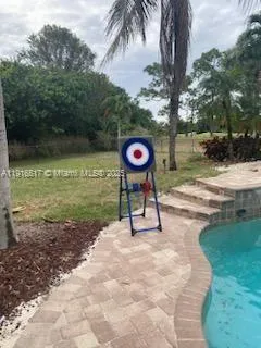 a view of a table and chairs under an umbrella