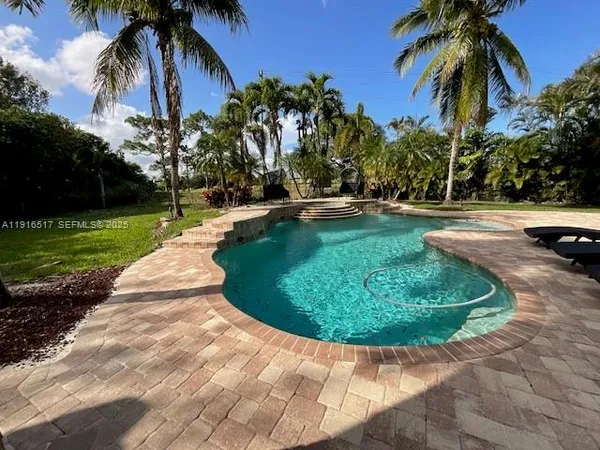 a view of a swimming pool with a garden
