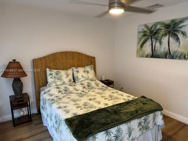 a bed sitting in a bedroom next to a lamp