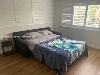 a bed sitting in a bedroom next to a window