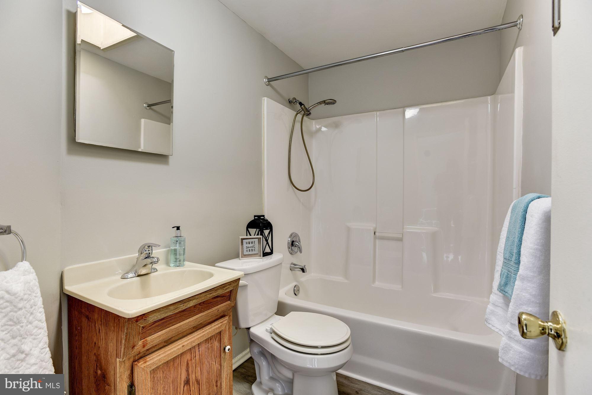 2759 Yarnall Road Baltimore, MD 21227 - Photo 12 of 21 a bathroom with a sink a toilet and a bathtub
