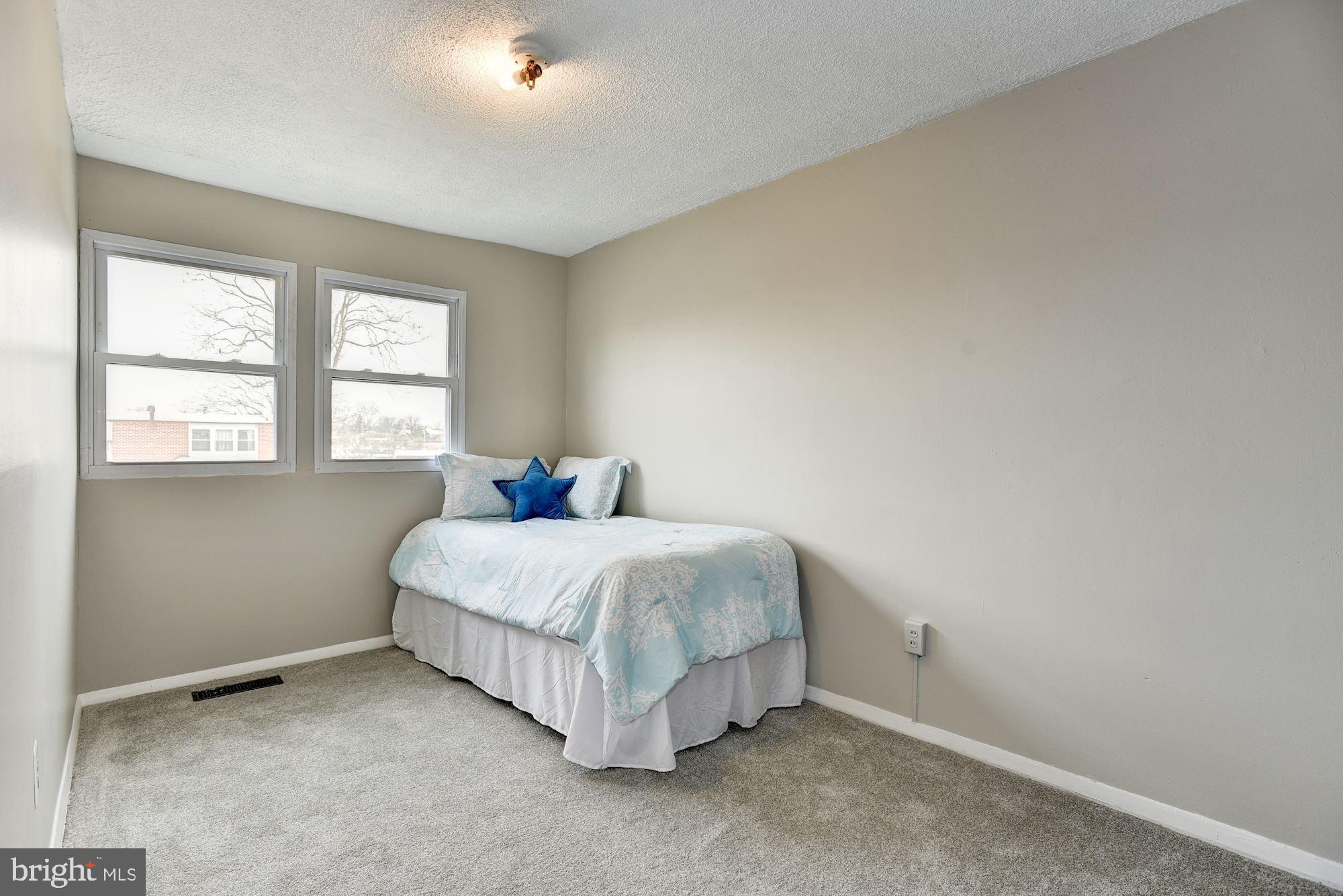 2759 Yarnall Road Baltimore, MD 21227 - Photo 13 of 21 a spacious bedroom with a bed and a window