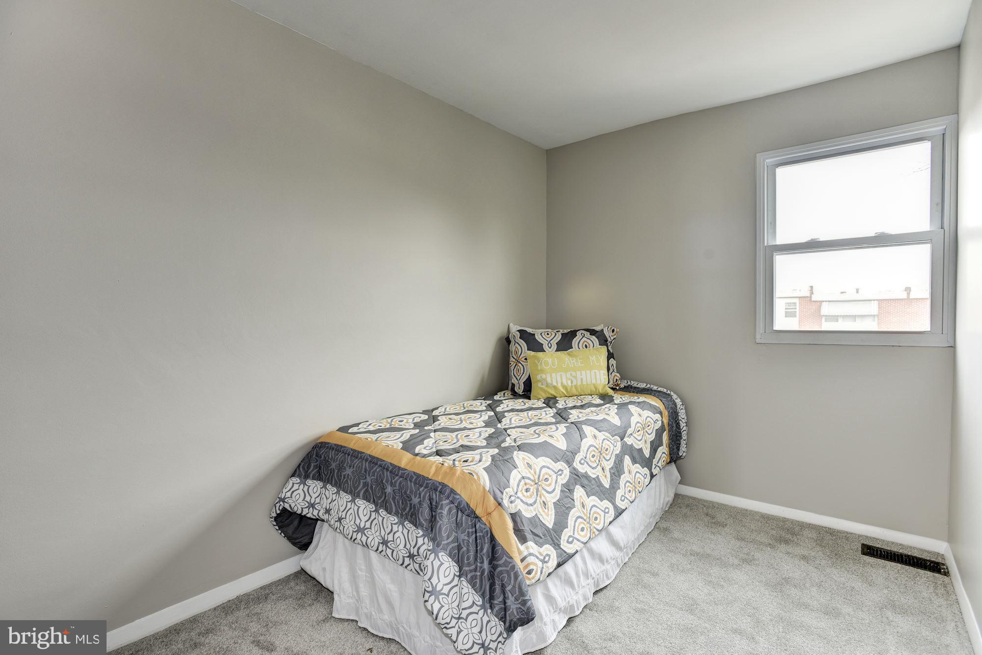 2759 Yarnall Road Baltimore, MD 21227 - Photo 14 of 21 a bedroom with a bed and window