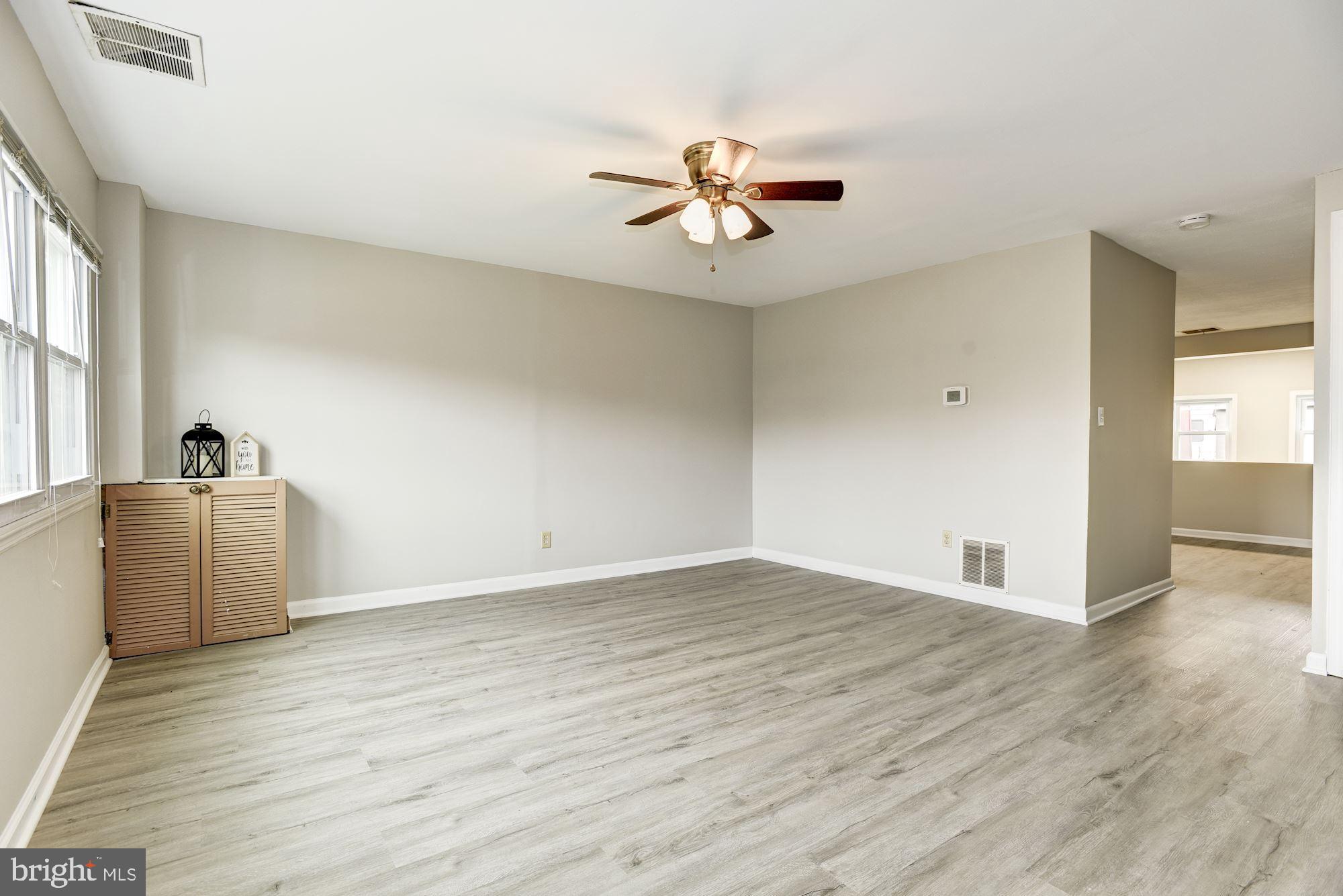 2759 Yarnall Road Baltimore, MD 21227 - Photo 4 of 21 a view of a livingroom with a ceiling fan and wooden floor