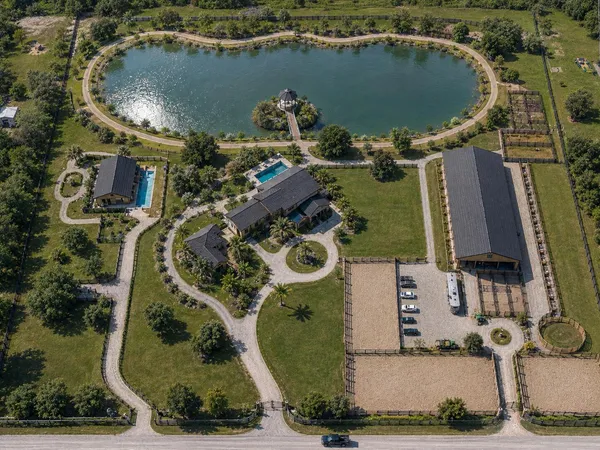 an aerial view of a house with a swimming pool