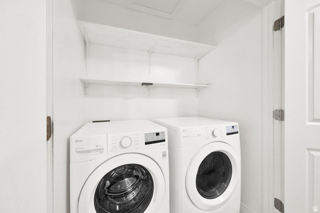 1179 West 100 South Springville, UT 84663 - Photo 18 of 32 Dedicated laundry area featuring a white front-load washer and dryer set, white shelving, and white walls