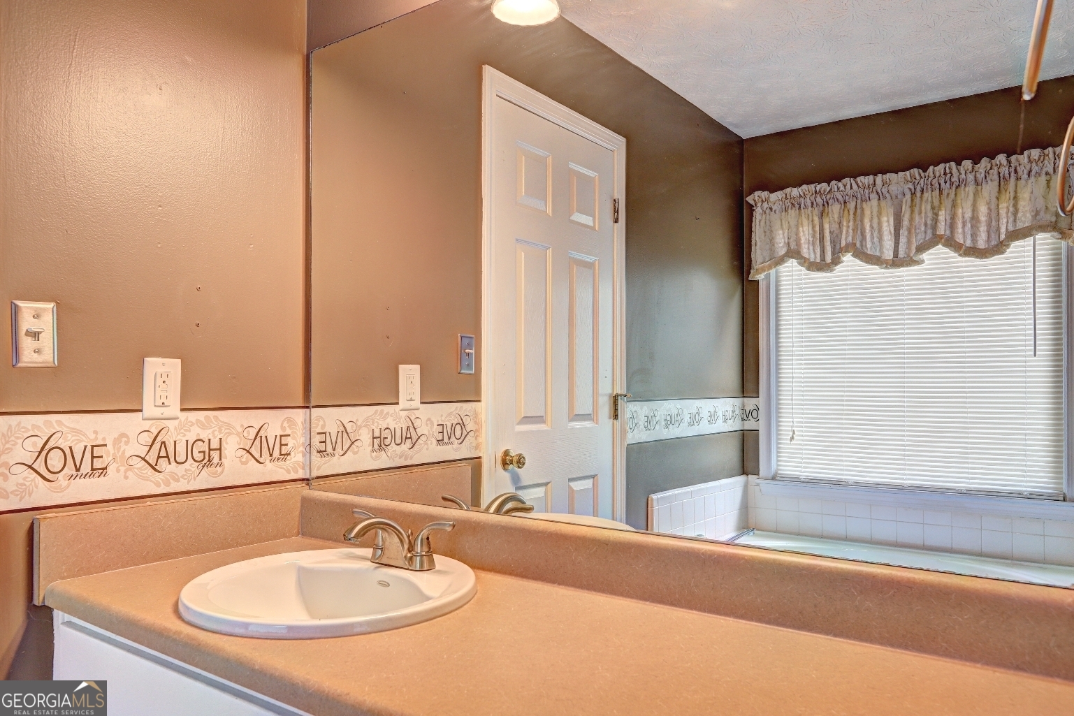 215 Laney Road McDonough, GA 30252 - Photo 19 of 38 a bathroom with a sink and a mirror