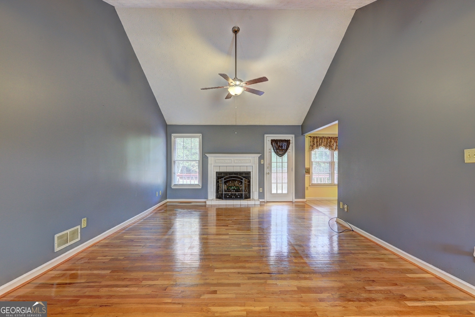 215 Laney Road McDonough, GA 30252 - Photo 2 of 38 a view of a livingroom with a fireplace a chandelier and wooden floor