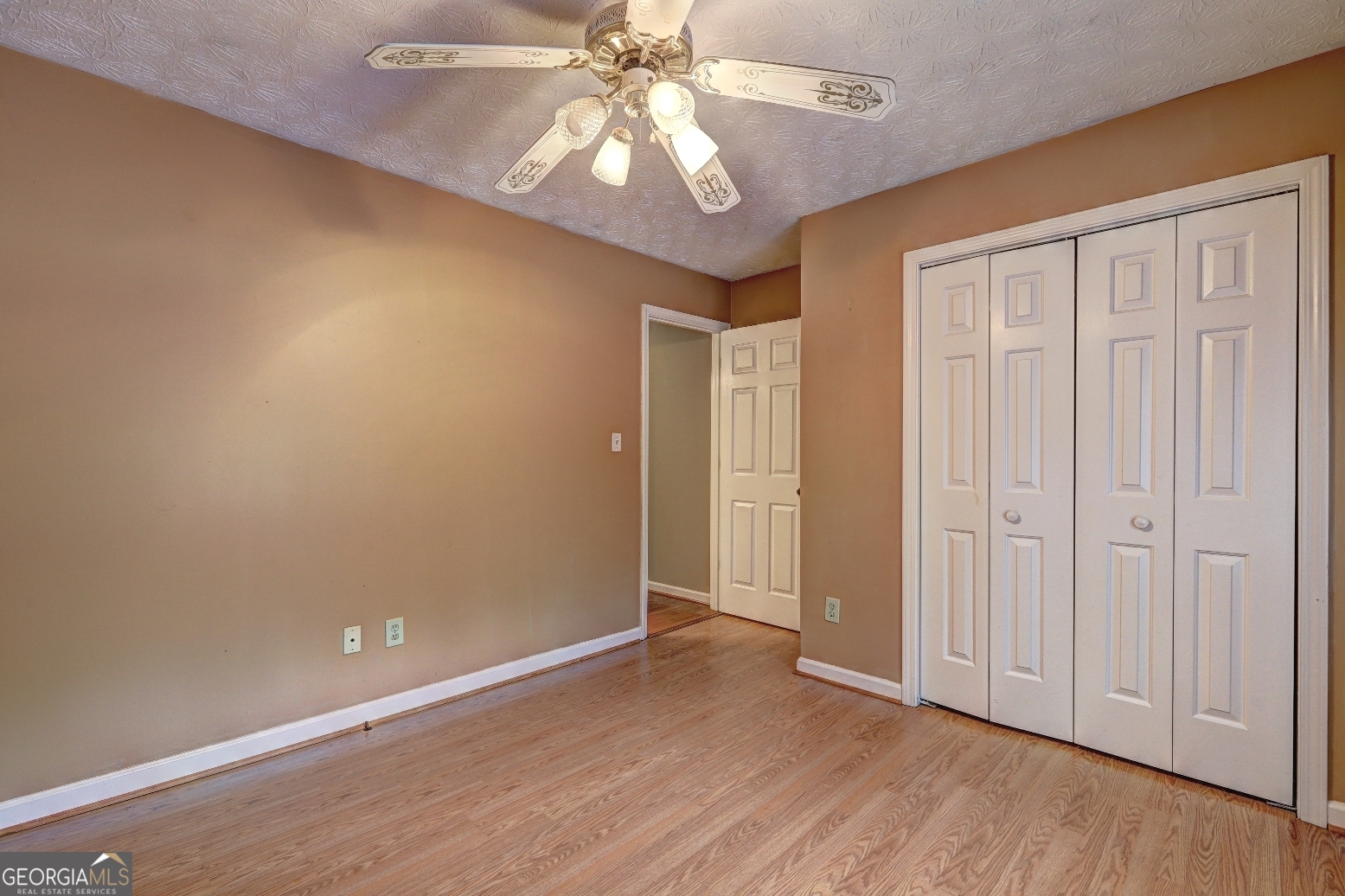 215 Laney Road McDonough, GA 30252 - Photo 22 of 38 an empty room with wooden floor closet fan and windows