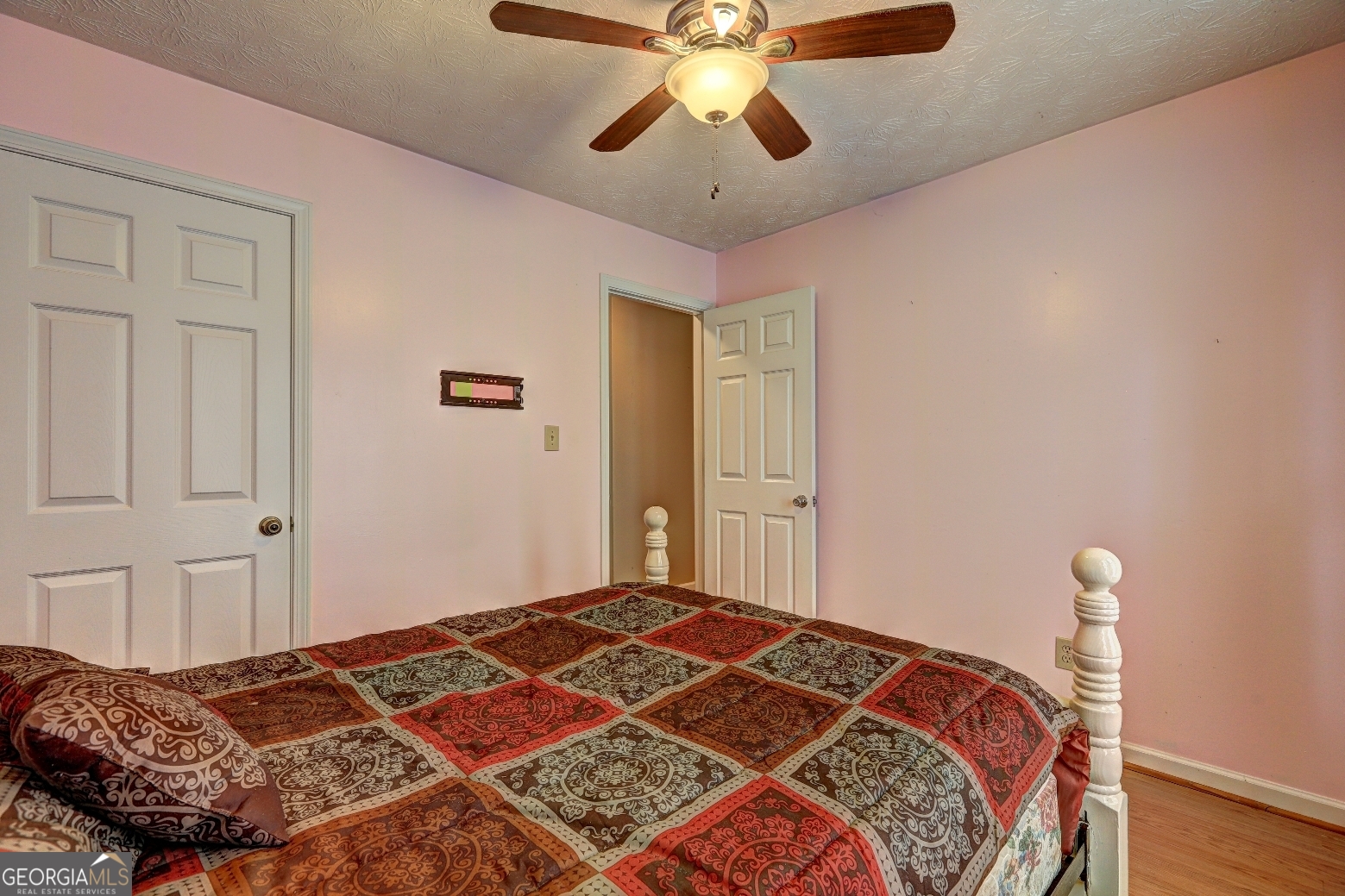 215 Laney Road McDonough, GA 30252 - Photo 25 of 38 a bedroom with a bed and a chandelier