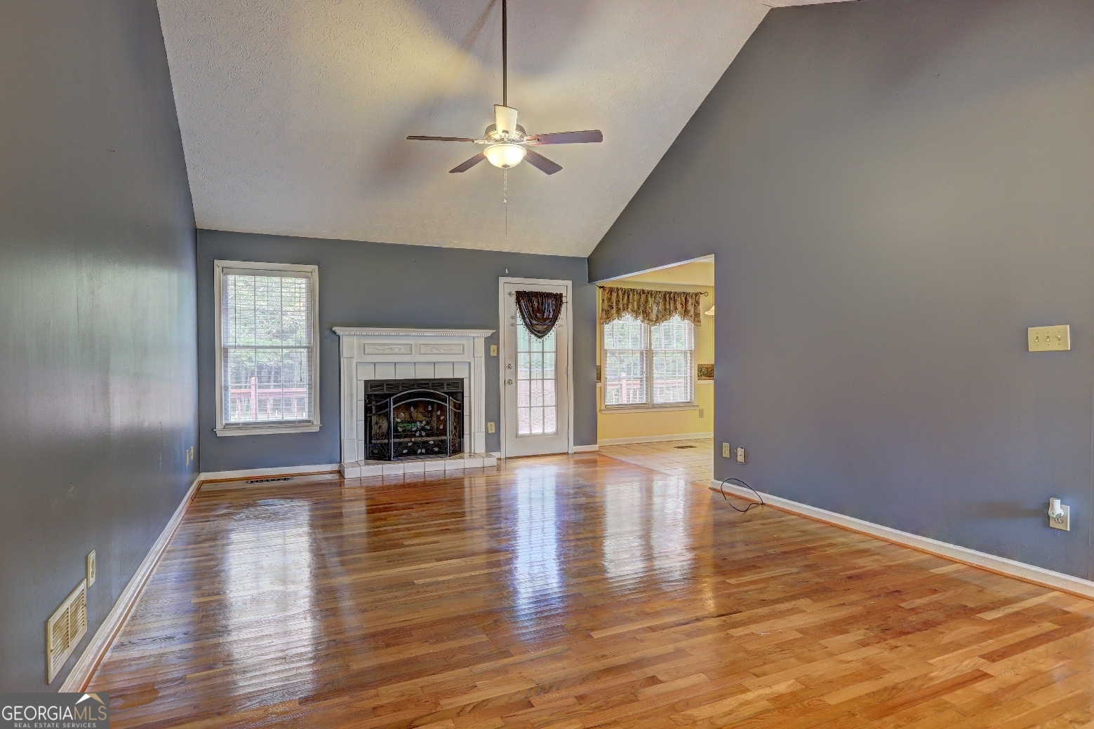 215 Laney Road McDonough, GA 30252 - Photo 3 of 38 a view of an empty room with wooden floor fireplace and a window