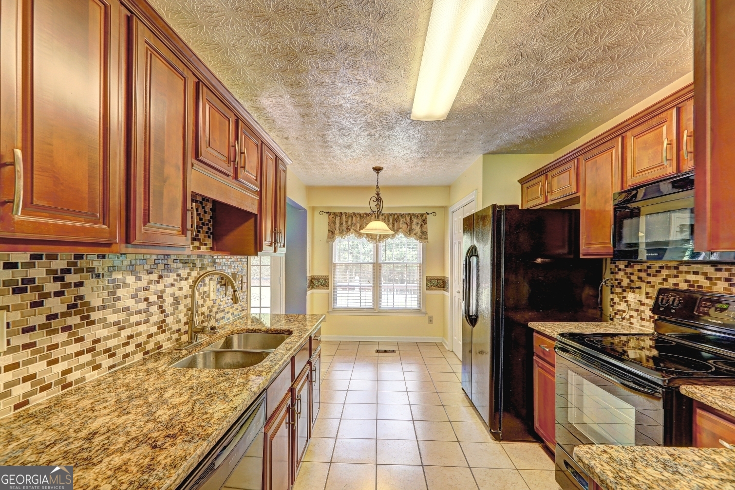 215 Laney Road McDonough, GA 30252 - Photo 9 of 38 a kitchen with granite countertop a sink stove and refrigerator