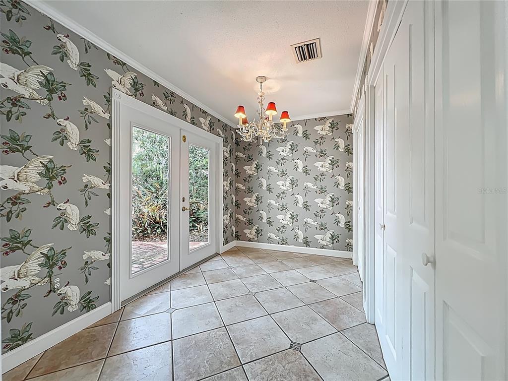 504 Banning Beach Road Tavares, FL 32778 - Photo 16 of 44 a view of an entryway with a flower pot and a window
