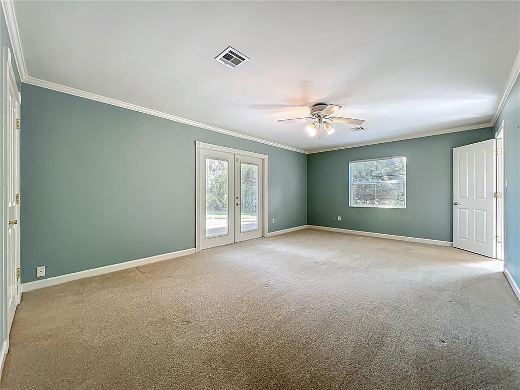 504 Banning Beach Road Tavares, FL 32778 - Photo 17 of 44 a view of a livingroom with a ceiling fan and window