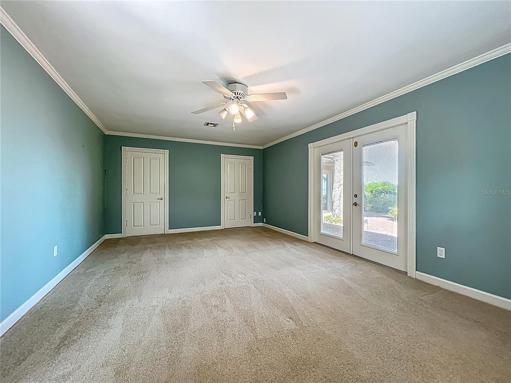 504 Banning Beach Road Tavares, FL 32778 - Photo 18 of 44 a view of an empty room with chandelier fan and a window