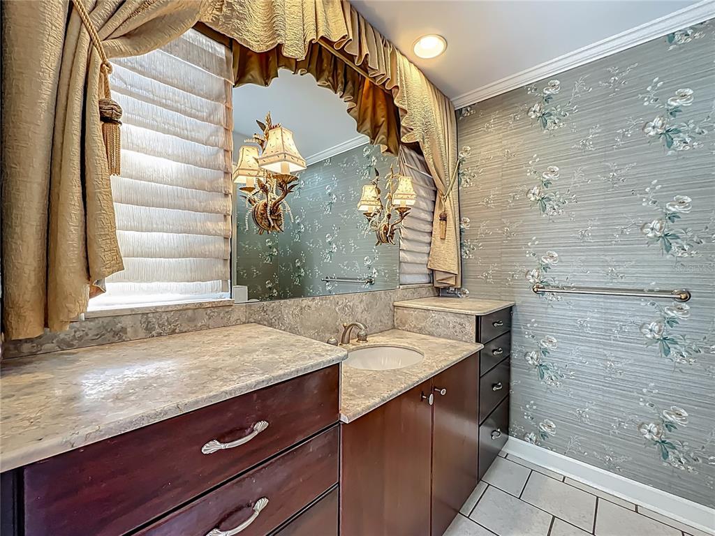 504 Banning Beach Road Tavares, FL 32778 - Photo 19 of 44 a bathroom with a sink and a mirror