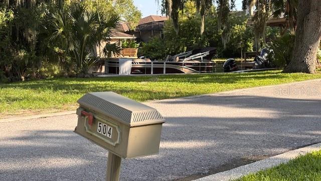 504 Banning Beach Road Tavares, FL 32778 - Photo 42 of 44 a view of a house with swimming pool and a yard