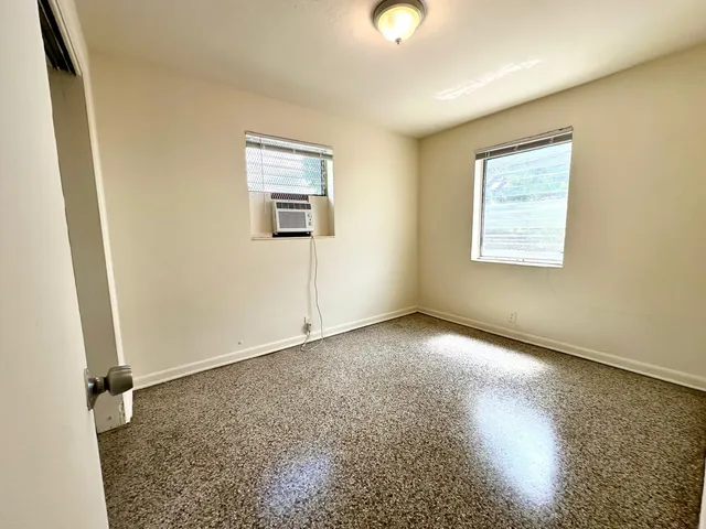 a view of an empty room and closet area