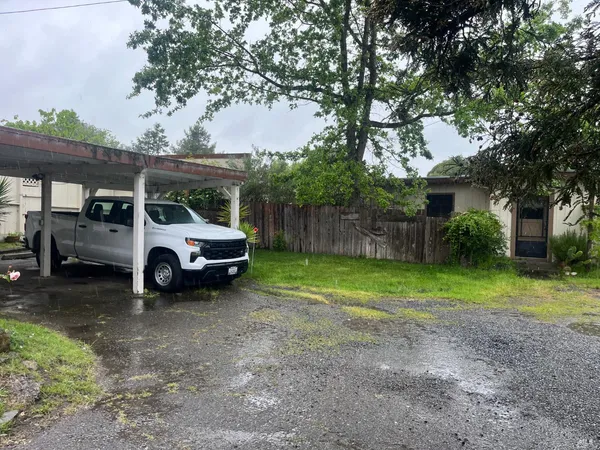 a view of a yard with car parked