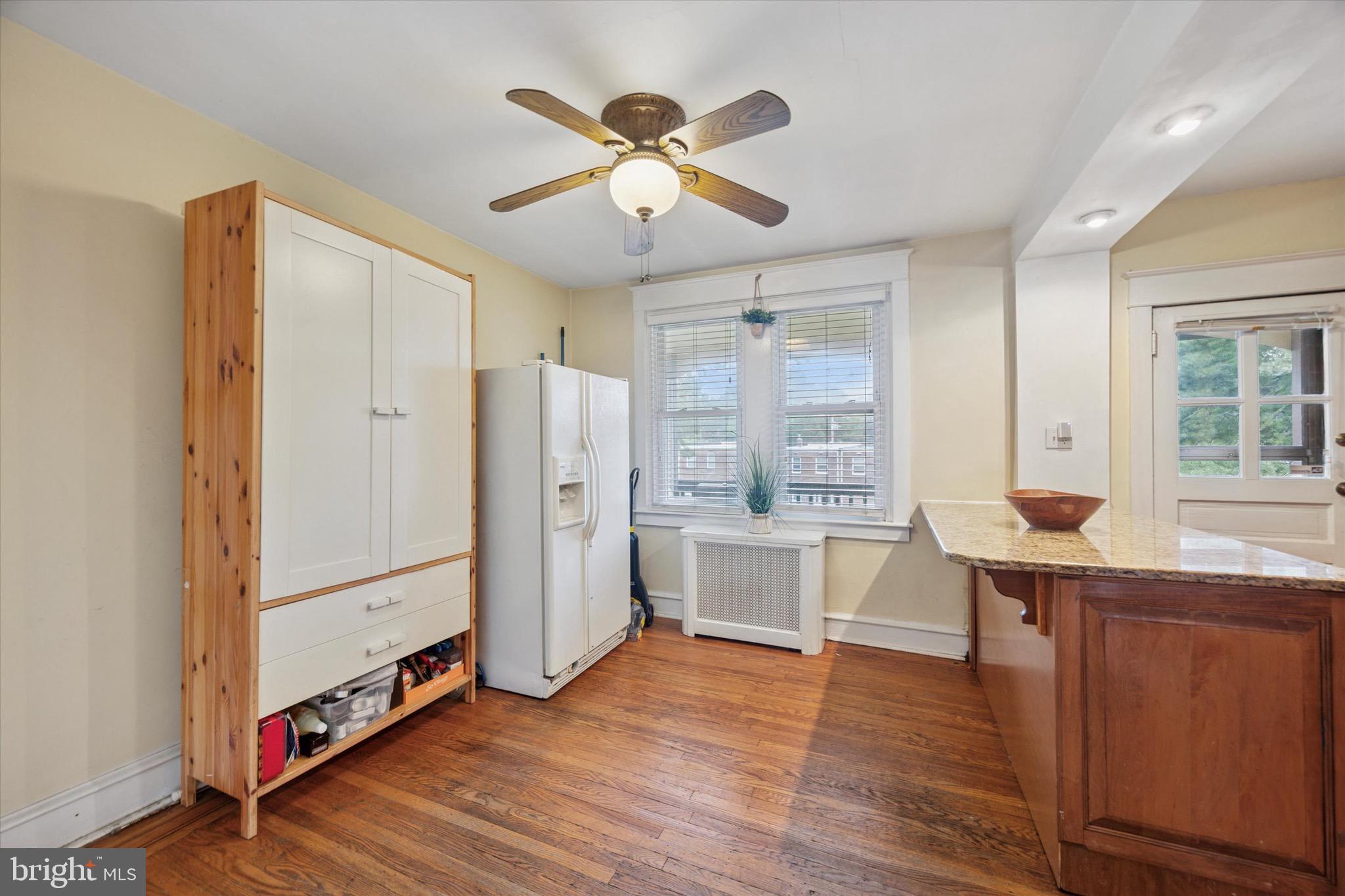 4930 State Road Drexel Hill, PA 19026 - Photo 7 of 18 a open kitchen with stainless steel appliances granite countertop a refrigerator a sink dishwasher a stove and white countertops with wooden floor