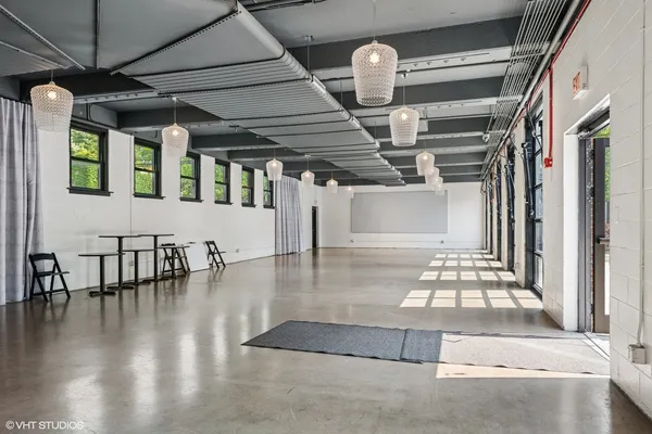 a view of a livingroom with an empty space and a window