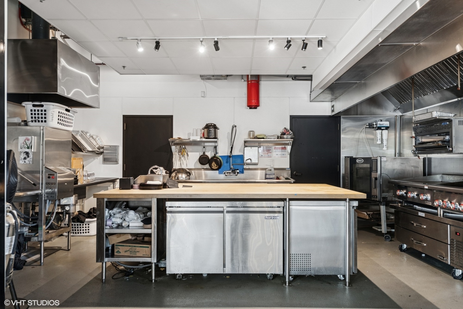 201 South Ashland Avenue Chicago, IL 60607 - Photo 20 of 41 a kitchen with kitchen island a white counter top space a sink stainless steel appliances and cabinets