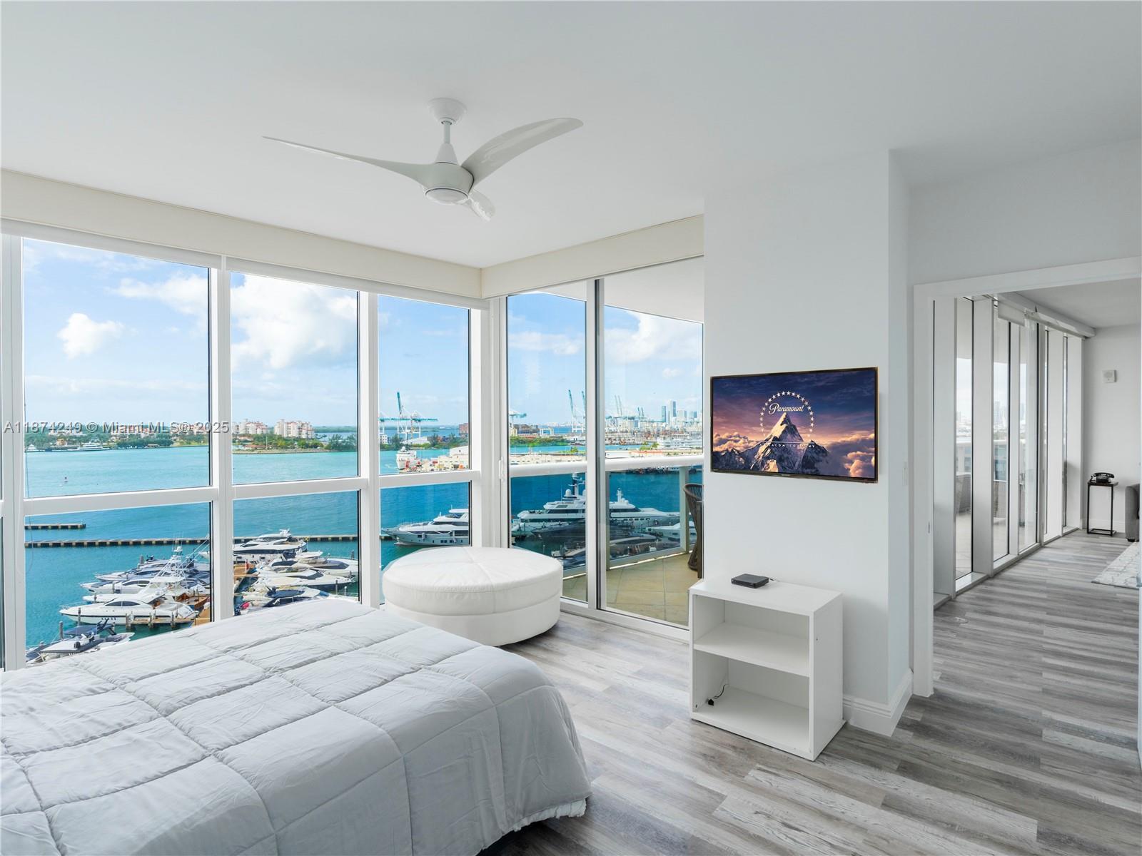 400 Alton Road, Unit 1104 Miami Beach, FL 33139 - Photo 13 of 27 a bedroom with a bed and a large window