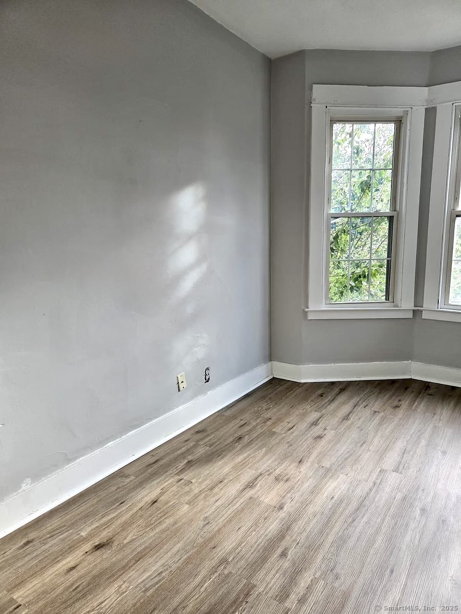 121 2nd Avenue West Haven, CT 06516 - Photo 13 of 17 an empty room with wooden floor and window