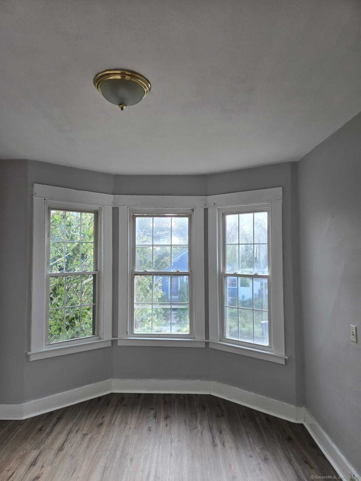 121 2nd Avenue West Haven, CT 06516 - Photo 15 of 17 an empty room with wooden floor and windows
