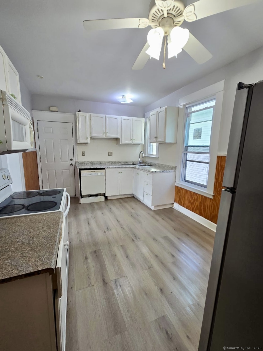 121 2nd Avenue West Haven, CT 06516 - Photo 2 of 17 a kitchen with stainless steel appliances granite countertop a refrigerator a sink dishwasher a stove and white countertops with wooden floor