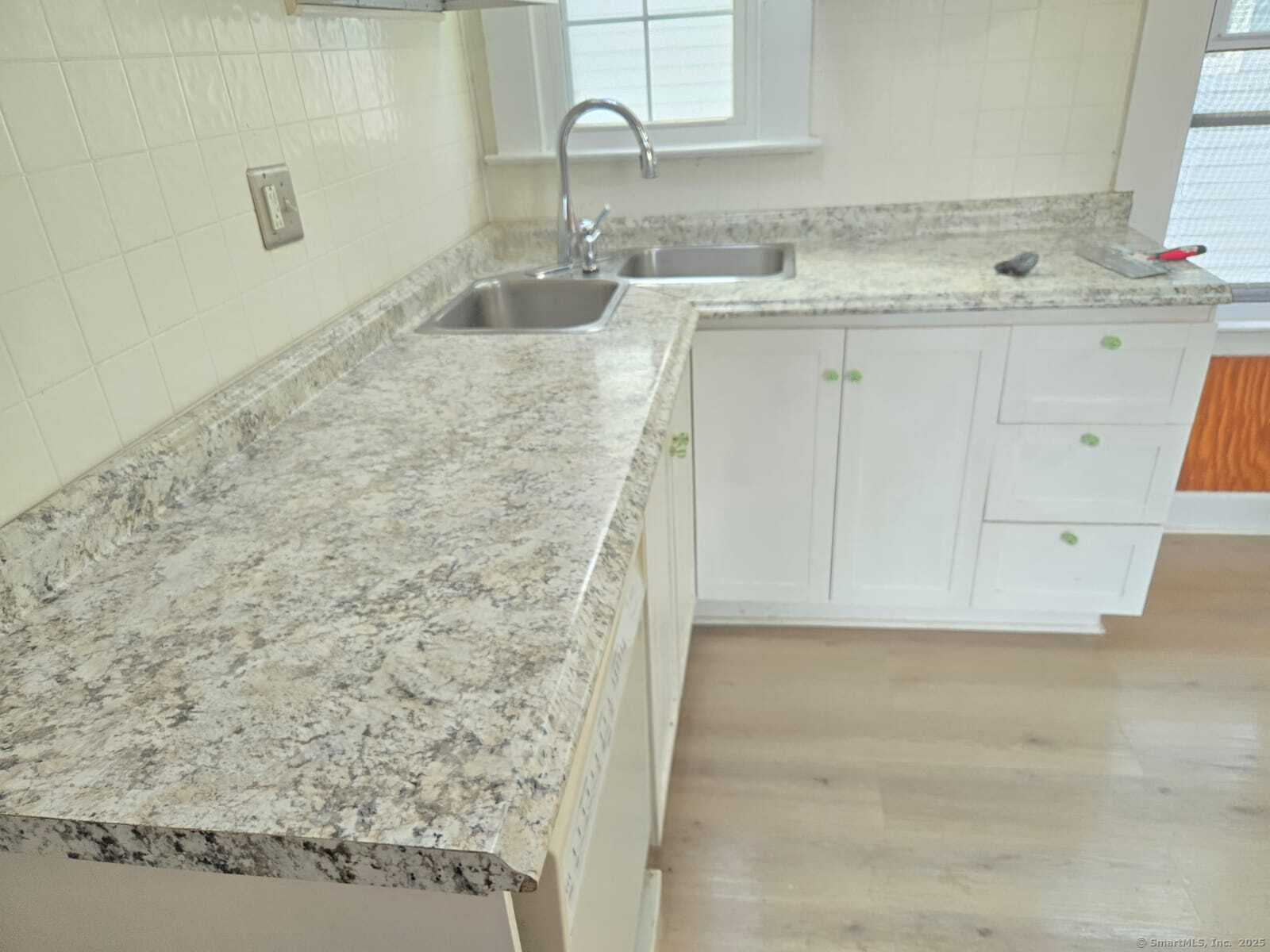 121 2nd Avenue West Haven, CT 06516 - Photo 4 of 17 a bathroom with a granite countertop sink and a mirror