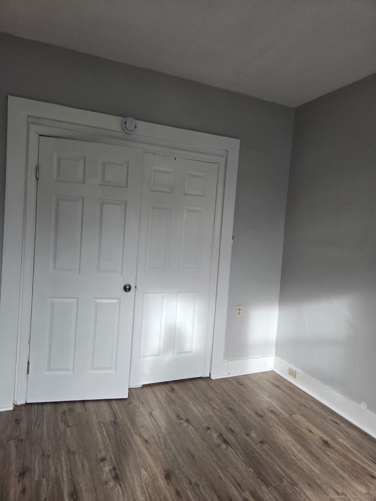 121 2nd Avenue West Haven, CT 06516 - Photo 5 of 17 a view of an empty room with wooden floor
