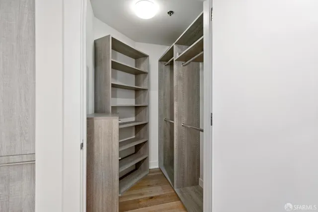 a view of walk in closet with empty racks