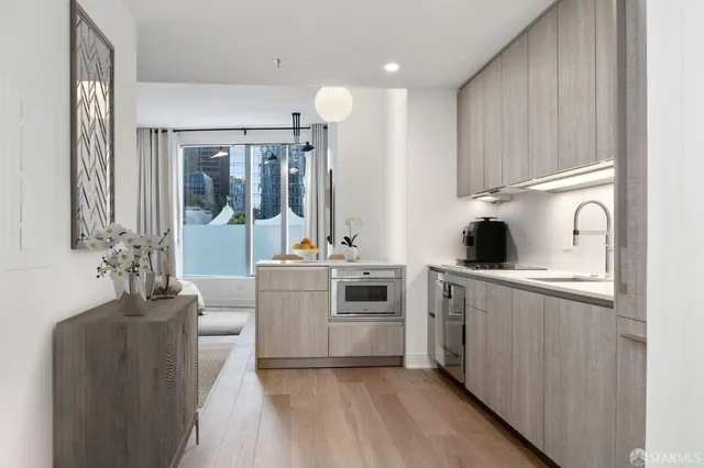 a kitchen with cabinets a sink and appliances